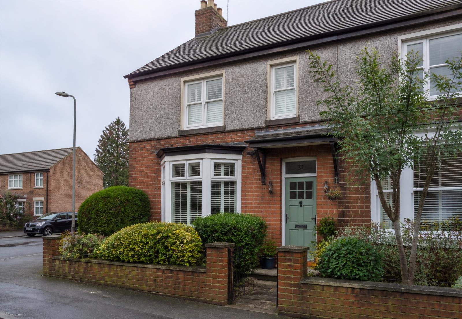 A modern British residential street with well-kept family homes